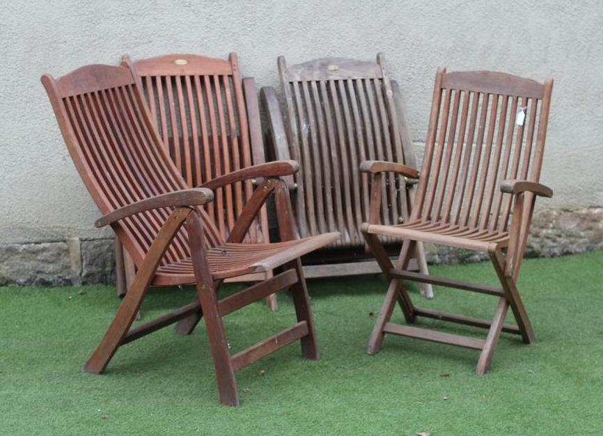 A SET OF FOUR TEAK FOLDING CHAIRS by Royal Croft, of slatted steamer type with arched top rails,