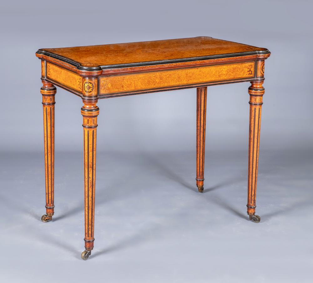 A FINE QUALITY AMBOYNA FOLDING CARD TABLE in the manner of Jackson & Graham, London, the earred