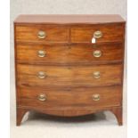 A REGENCY MAHOGANY BOWED CHEST, the moulded edged top over two short and three long drawers with