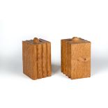 A PAIR OF PETER HEAP ADZED OAK BOOKENDS each carved as four books surmounted by a rabbit trademark