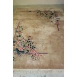 A CHINESE WASHED AND FRINGED CARPET, modern, featuring sprays of flowering peonies in pink and green