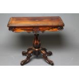 AN EARLY VICTORIAN ROSEWOOD FOLDING CARD TABLE of rounded oblong form, the moulded edged swivel
