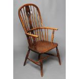 A WINDSOR SPINDLE BACK ARMCHAIR in ash and elm, early/mid 19th century, of high hooped form with