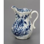 A FIRST PERIOD WORCESTER PORCELAIN MILK JUG, c.1760, of faceted baluster form painted in