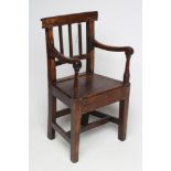 A CHILD'S ELM ARMCHAIR, 19th century, the three bar back with straight top rail, down turned arms on