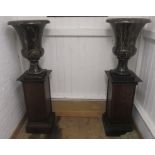 A PAIR OF VEINED BLACK MARBLE URNS, modern, of campana form with waisted socle and square base,