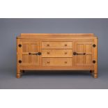 A ROBERT THOMPSON ADZED OAK SIDEBOARD, of canted oblong form with ledge back on moulded edged top,