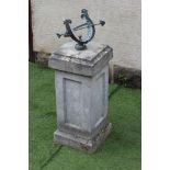 A COMPOSITE STONE SUNDIAL, the bronzed metal armillary dial raised on square panelled plinth with
