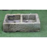 A SANDSTONE TROUGH of well cut oblong form with central division, 32" x 18" x 9", together with a
