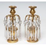 A PAIR OF REGENCY GILT METAL CANDLE LUSTRES, the detachable flowerhead cast drip pans in reeded