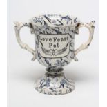 A PEARLWARE LOVING CUP, c.1830, the bell shaped bowl inscribed in black "Love Feast Pot", on a