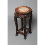 A CHINESE PADOUK WOOD JARDINIERE STAND, the beaded edged shaped circular top inset with red