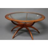 A G PLAN TEAK "SPIDER" COFFEE TABLE, the circular top with inset clear glass panel, on turned