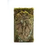 A CARVED SANDSTONE "GREEN MAN" WALL PLAQUE, late 19th century(?), the grotesque mask crisply