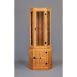 A ROBERT THOMPSON ADZED OAK STANDING CORNER CUPBOARD of two staged canted form with half penny