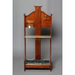 AN EDWARDIAN MAHOGANY STICK STAND, the arched open back with central splat carved with linen fold,