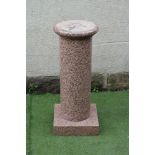 A PINK GRANITE STAND, modern, the turned column with moulded base