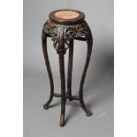 A CHINESE HARDWOOD JARDINIERE STAND, c.1900, the reeded circular top inset with red marble, the