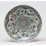 A CHINESE PORCELAIN SAUCER DISH of plain circular form, painted in famille verte enamels with