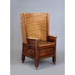 AN ORKNEY PINE ARMCHAIR, 19th century, with woven straw back, scrolled arms, panelled box base