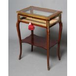 A VICTORIAN MAHOGANY AND GILT METAL MOUNTED BIJOUTERIE TABLE, of shaped oblong form with bevelled