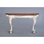 A CARVED AND PAINTED MAHOGANY(?) CONSOLE TABLE, 19th century, of serpentine form, moulded edged
