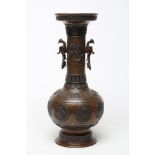 A JAPANESE BRONZE VASE of baluster form with cast and applied dragon handles and panels of