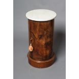 A VICTORIAN BURR WALNUT CYLINDRICAL BEDSIDE CUPBOARD with white marble top, door below with turned