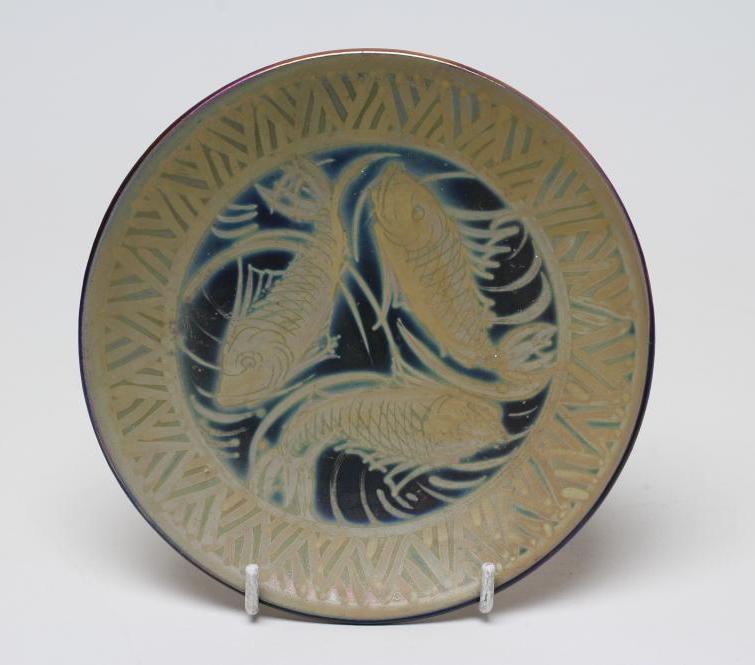 A BURMANTOFTS FAIENCE PLATE of plain circular form painted by J. Walmsley in iridescent pink/blue/