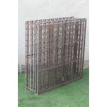A WROUGHT AND CAST IRON WINE RACK, possibly French 19th century, the shallow oblong slatted cage