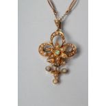 AN EDWARDIAN PENDANT/BROOCH, the open trefoil centred by a star all set with seed pearls and opal