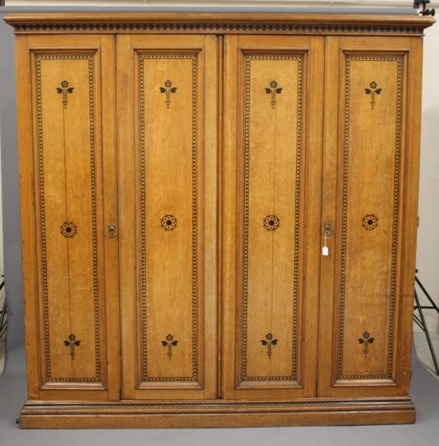 A GOTHIC REVIVAL LIGHT OAK AND BLACK STENCILLED WARDROBE, in the manner of Marsh, Jones & Cribb, the