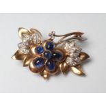 A SAPPHIRE AND DIAMOND FLOWER BROOCH, the six cabochon polished sapphires collet set to plain leaves