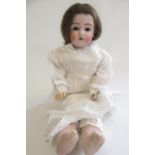 A Kestner bisque shoulder head doll with brown glass sleeping eyes, open mouth with four top