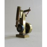 A small oscillating steam engine made using a 303 built case, brass construction and brass fly wheel