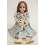 A Kestner bisque socket head doll with brown glass sleeping eyes, open mouth, four moulded top