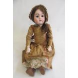 A Max Handwerck bisque socket head doll with brown glass sleeping eyes, open mouth with four moulded