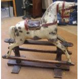 A rocking horse, possibly Lines Bros., early 20th century, painted wood, head to one side, black/