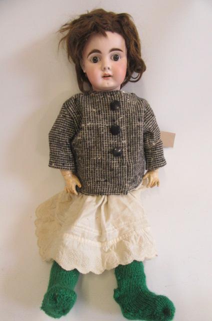 A Kestner bisque socket head doll, with brown glass fixed eyes, open mouth with four moulded