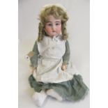 A Kammer & Reinhardt bisque socket head doll, with blue glass sleeping eyes, open mouth with four