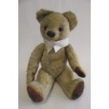 A Chad Valley teddy, c.1940, with rotating joints, amber button eyes and dress collar, 22" high (