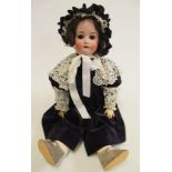 A Kestner bisque socket head doll with brown glass sleeping eyes, open mouth with four top teeth,