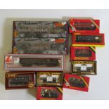 Eleven goods wagons by Bachmann and Hornby including petrol tankers, coal trucks and P.O. wagons,