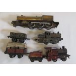 Two playworn Bing live steam locomotives, two Bing goods trucks and a part built 4-6-0 O gauge G.W.