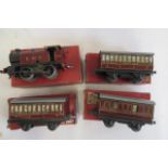 Hornby Clockwork 101 L.M.S. Tank Locomotive, paint damage P, and three L.M.S. No1 Passenger Coaches,