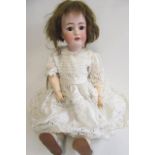 A Franz Schmidt & Co. bisque socket head doll with brown glass sleeping eyes, open mouth with four