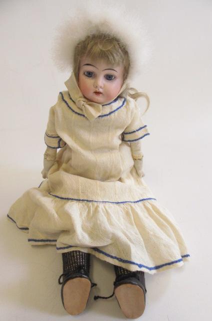 A Kley & Hahn bisque shoulder head doll, with blue glass fixed eyes, open mouth with four teeth,