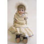 A Kley & Hahn bisque shoulder head doll, with blue glass fixed eyes, open mouth with four teeth,