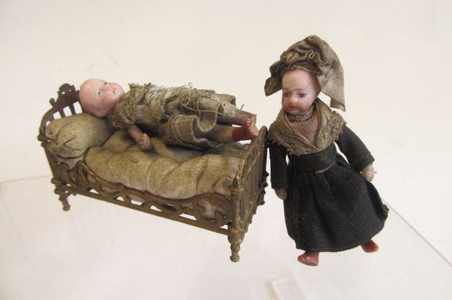 A pair of French all bisque dolls house dolls, hinged necks, shoulders and hips, both 2 1/2",