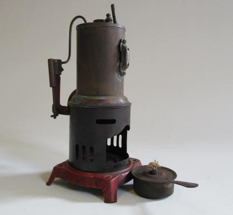 A German made small vertical steam engine with single cylinder and spirit fired boiler, missing
